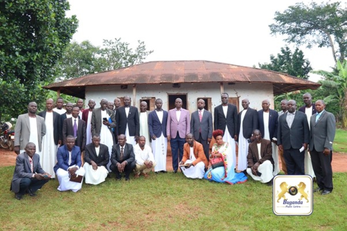 They are in a group photo at the ancestral home of the Enkejje Clan Image